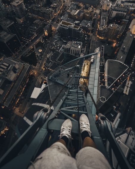 person standing on gray steel frame on top of building