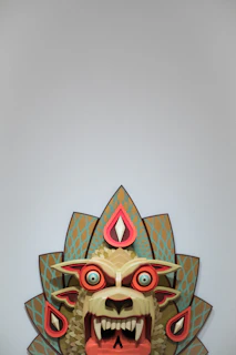 Artisanal horror mask with muted red accents and a grotesque, asymmetrical design.