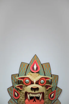 Close-up of a lively Therian mask with bold colors and smooth lines.