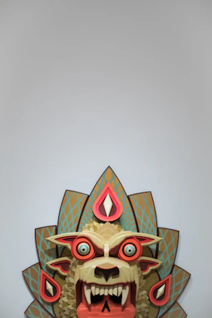 Artisanal horror mask with muted red accents and a grotesque, asymmetrical design.