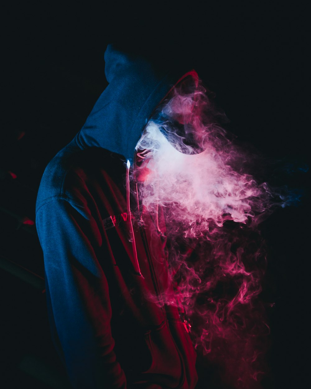 man in black hoodie smoking