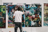 man wearing white shirt painting a wall