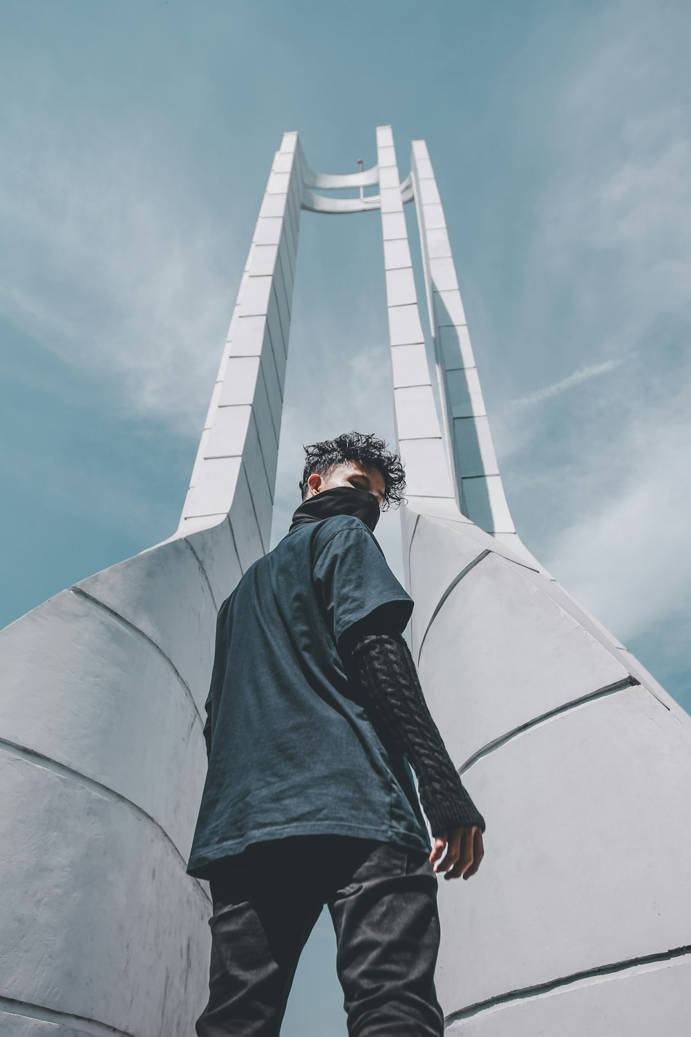 man in black shirt standing at the front of tower