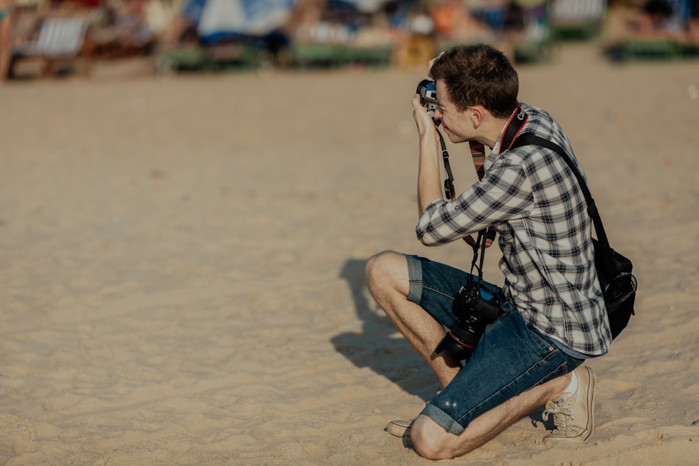 man kneeling taking photo