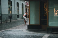 A candid shot of a couple exchanging a warm embrace in a city street.