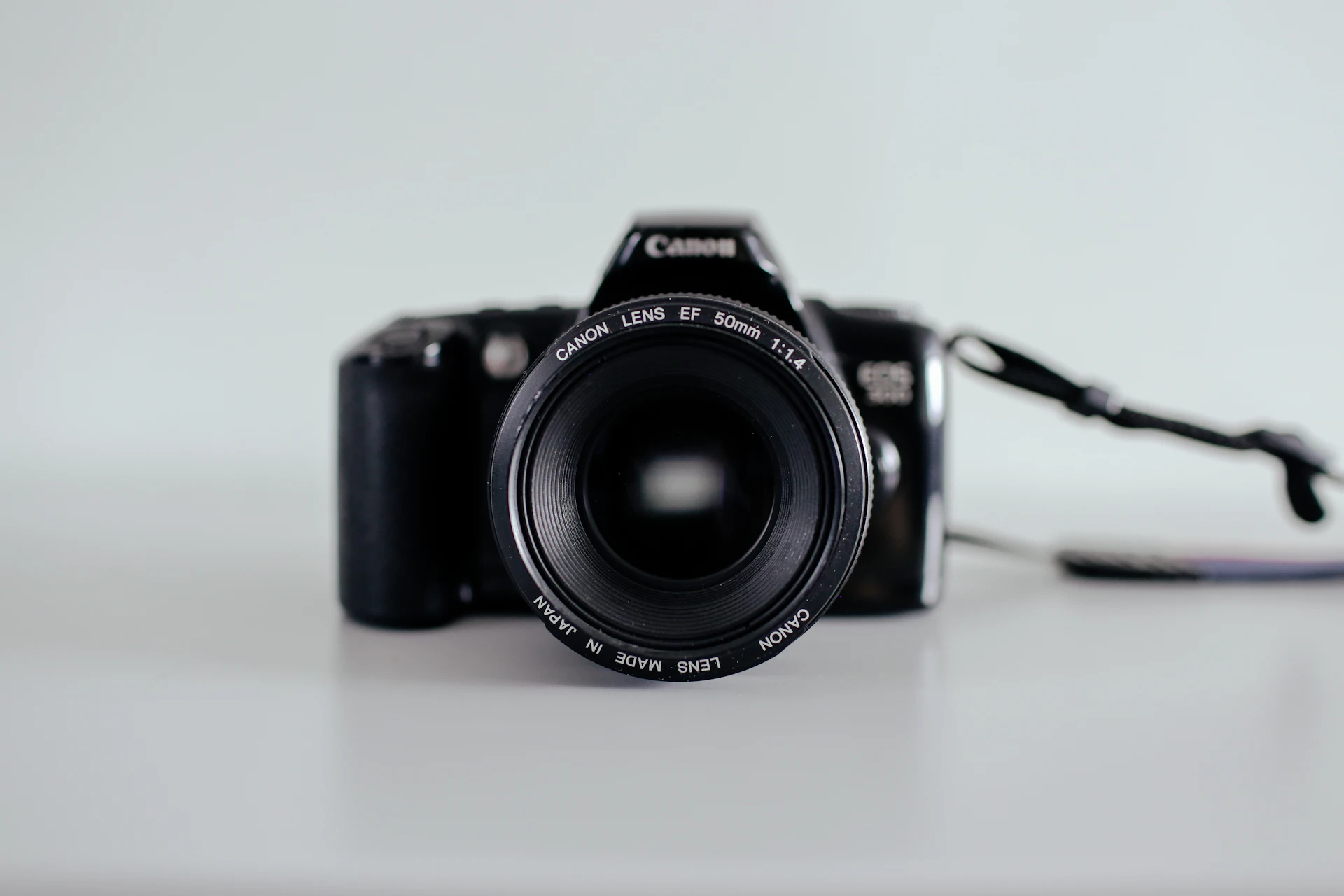 Professional camera lens on a dark surface