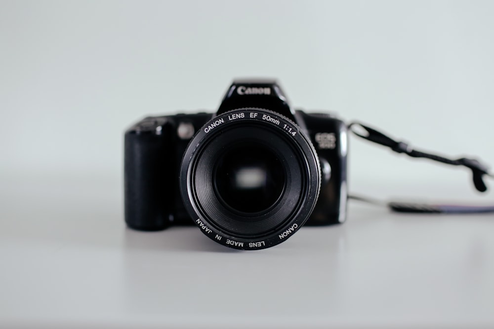 selective focus photo of black Canon DSLR camera