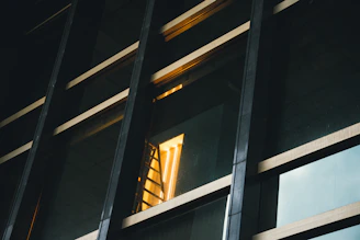 Reflections on the polished light gray floor mirroring the glass pillars and soft studio lighting.