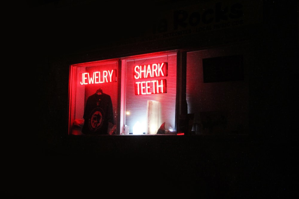 Shark Teeth neon signage on glass window