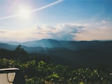 A landscape photograph featuring rolling hills under a bright blue sky.