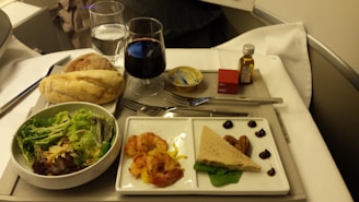A gourmet meal served on an airplane tray.
