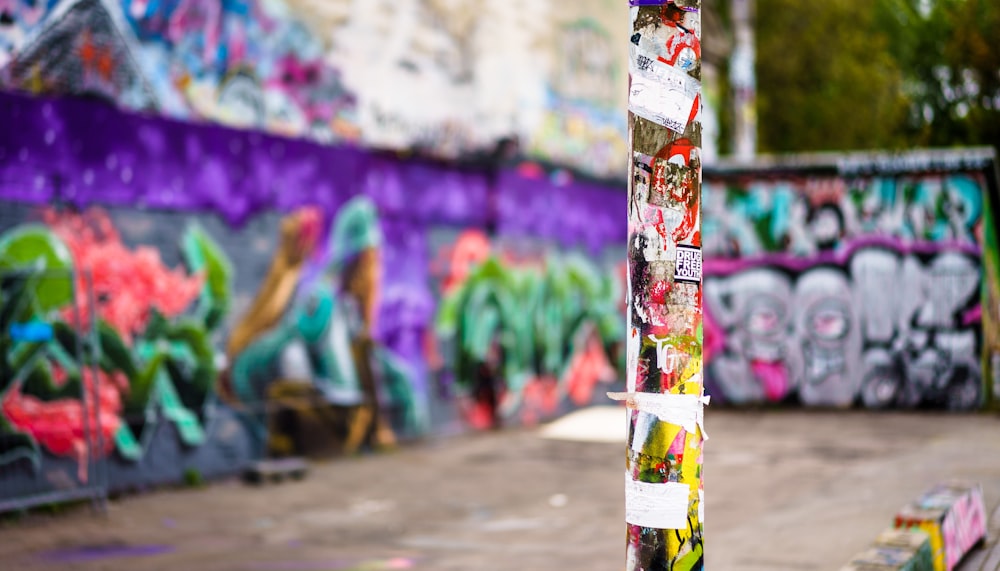 selective focus photography of rod with graffiti