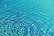 Close-up of clear blue pool water with gentle ripples reflecting sunlight.