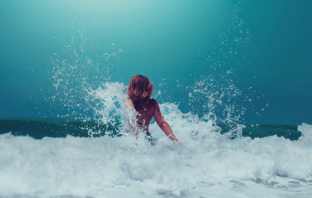 Mujer sentada en la orilla del mar