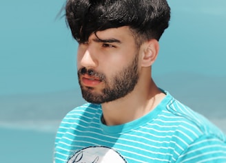 A serene navy blue background with subtle terracotta accents framing a thoughtful man looking contemplatively into the distance.