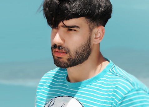 A serene navy blue background with subtle terracotta accents framing a thoughtful man looking contemplatively into the distance.