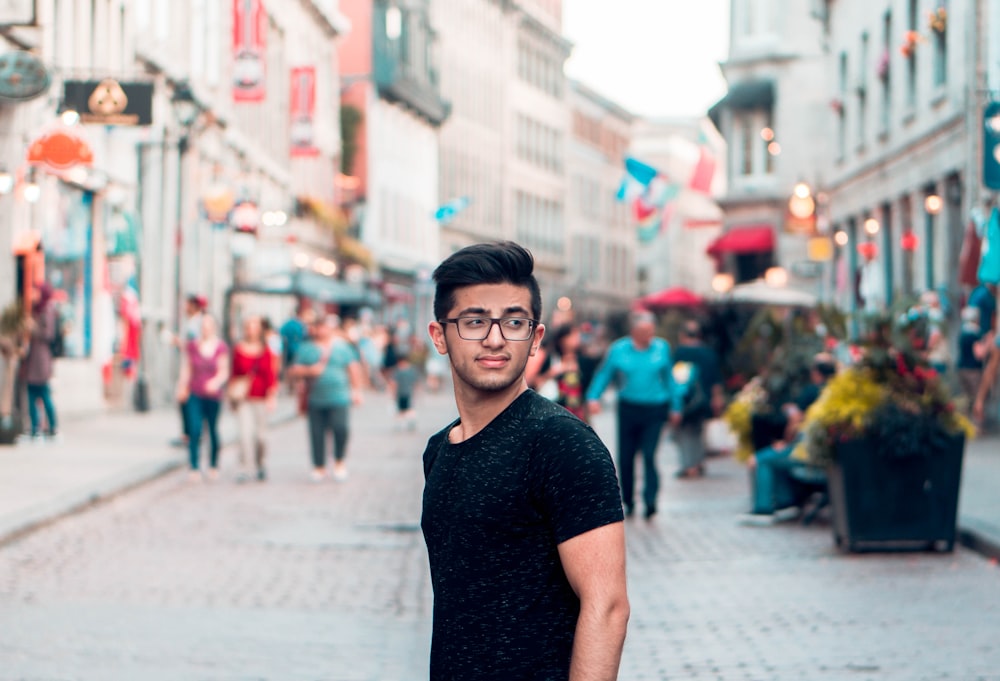 man wearing black crew-neck T-shirt during daytime