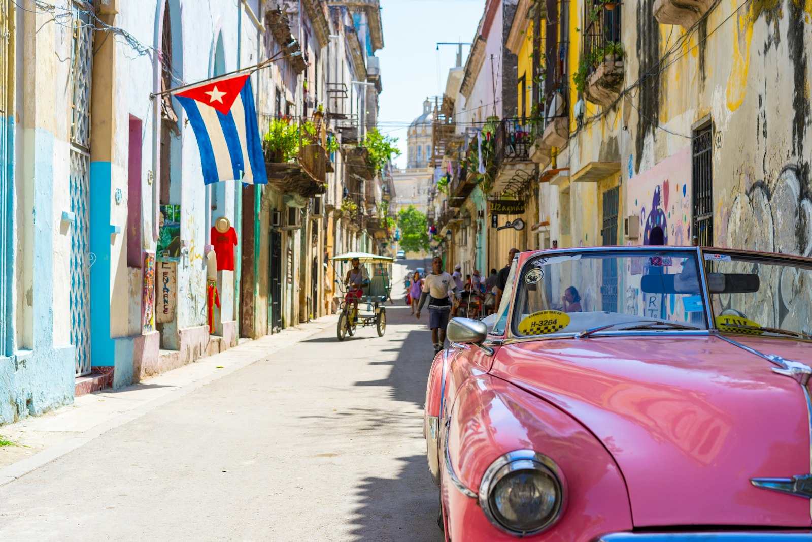Colorful Havana street scene with vintage cars