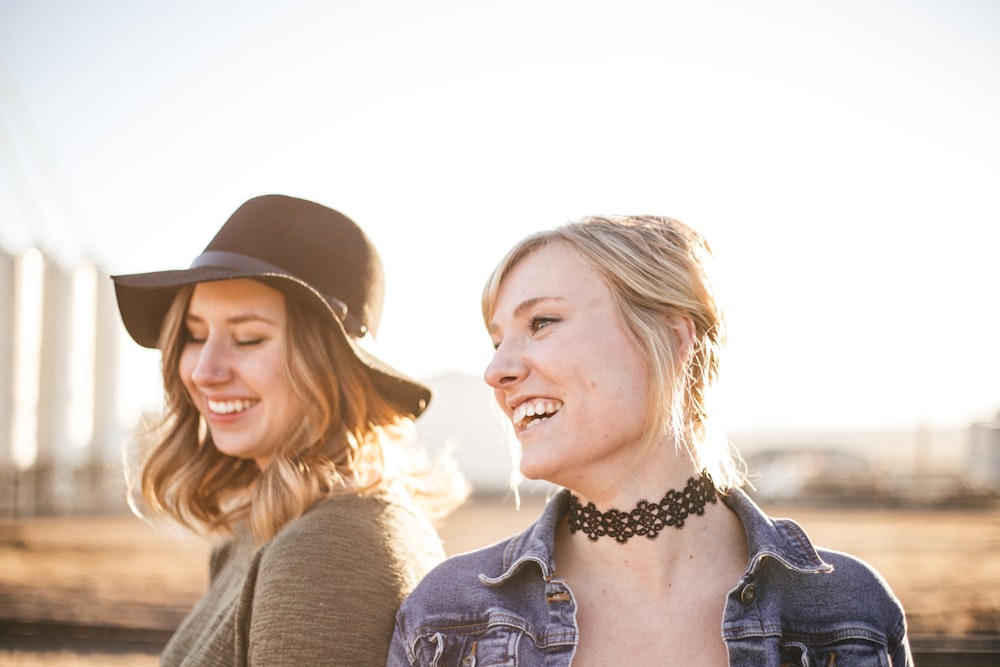 two woman taking a sideview selfie