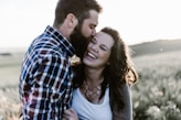 man kissing woman in grass area