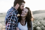 man kissing woman in grass area