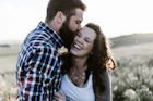 man kissing woman in grass area