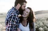 man kissing woman in grass area