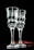 Two elegant, clear glass goblets with a textured, wavy surface are positioned side by side against a dark background. Subtle reflections and highlights add depth to the transparent material, creating a sophisticated and refined atmosphere.