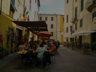 A cozy outdoor café scene with travelers relaxing and chatting.