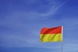 An image of the Kurdistan flag with a vibrant yellow background.