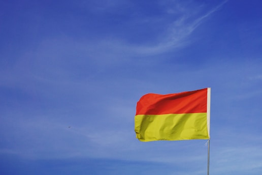 An image of the Kurdistan flag with a vibrant yellow background.