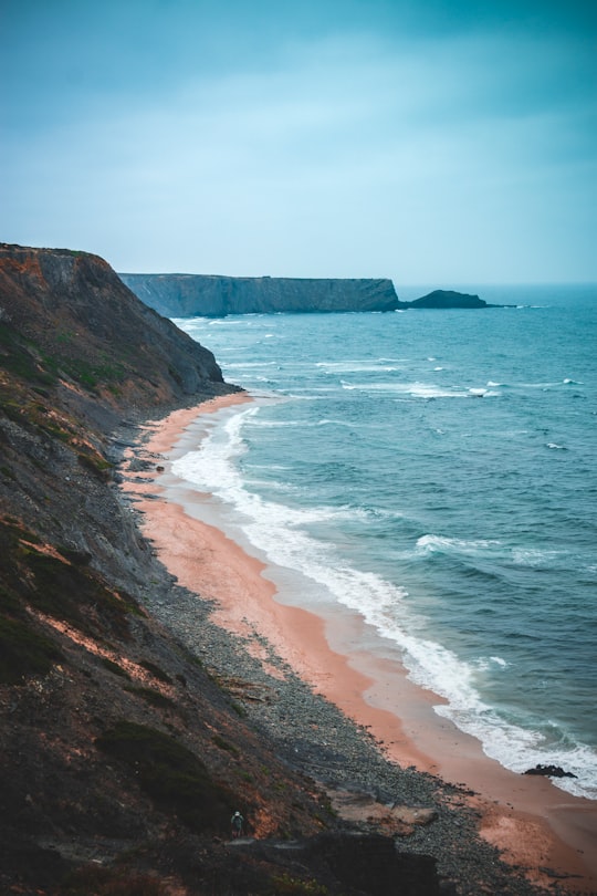 rock cliff near shore in Monte Clérigo beach Portugal
