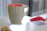 Close-up of a sleek planner mug on a modern desk with logistics charts in the background.