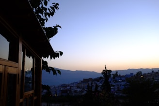 A serene landscape photograph blending urban and natural elements at dusk, symbolizing cultural intersections.