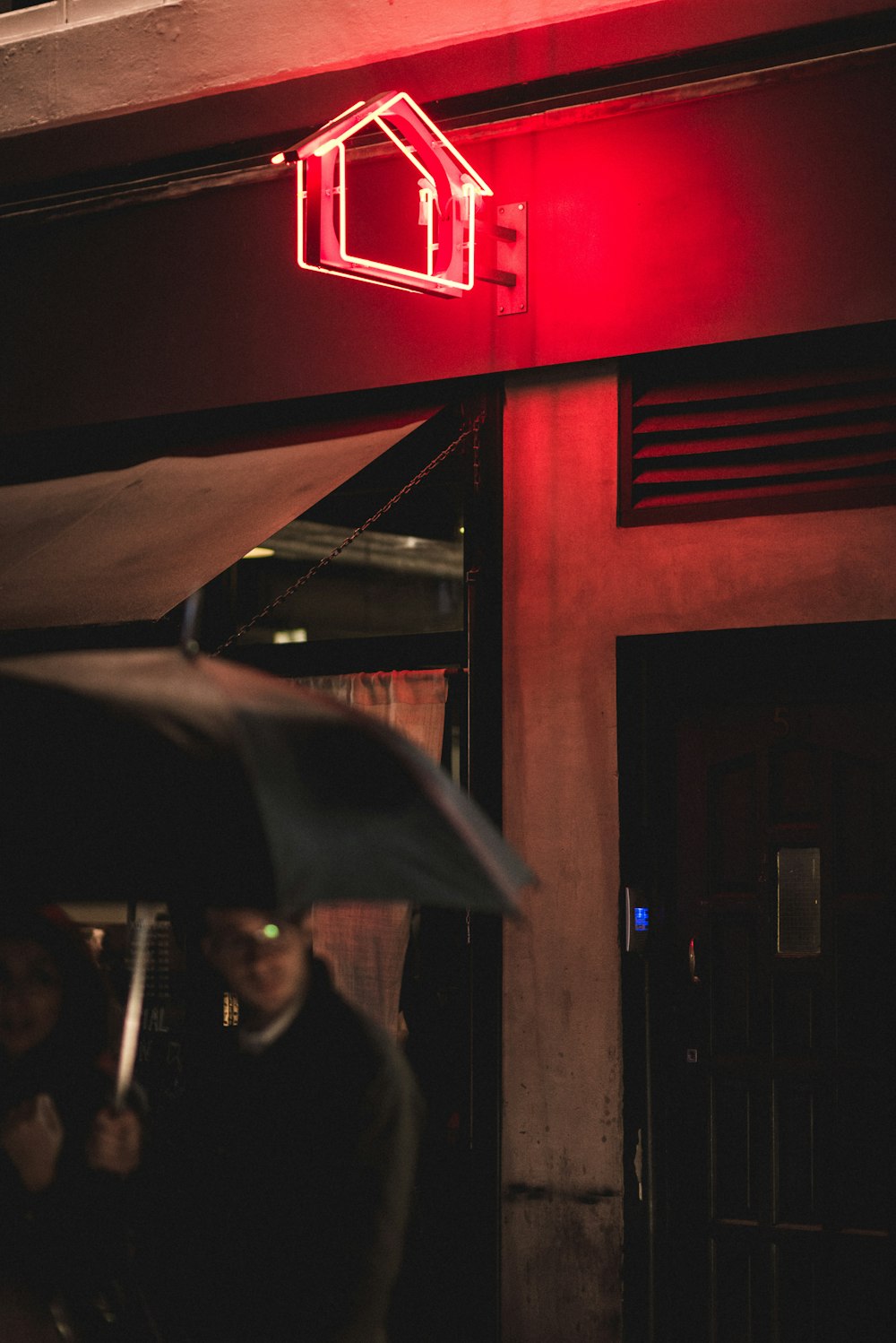 man under black umbrella