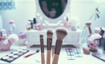 macro shot of three brown makeup brushes
