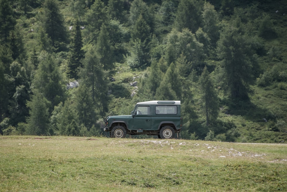 green off-road vehicle on green grass field