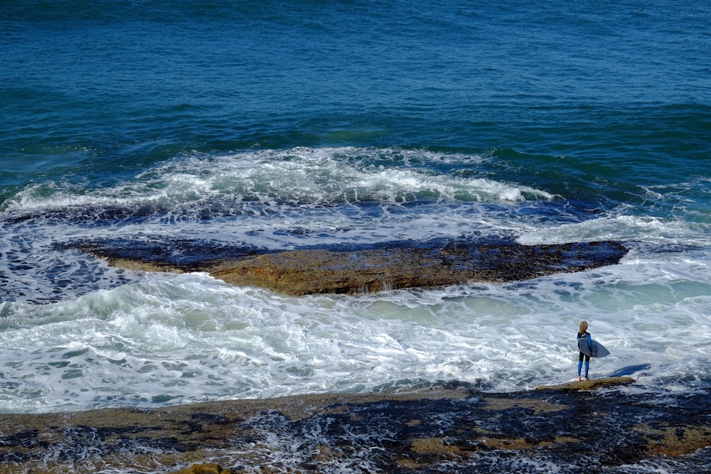 person about to surf on shore