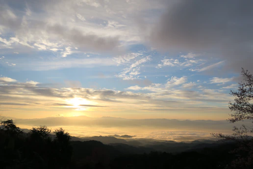 A peaceful sunrise over a quiet valley, symbolizing hope and new beginnings.
