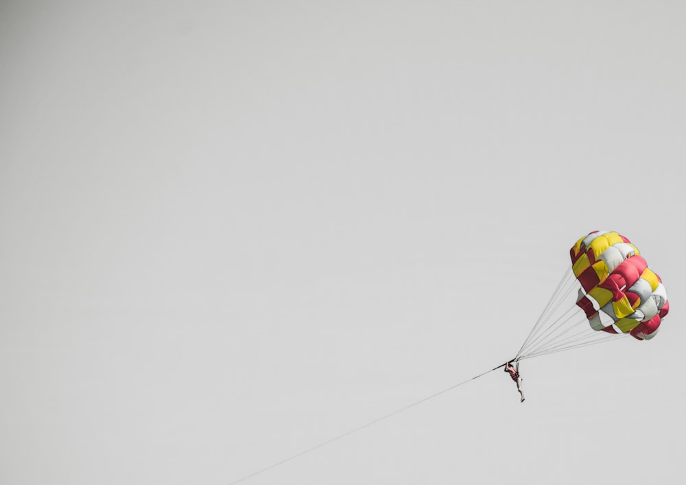 person riding on a parasailing during daytime