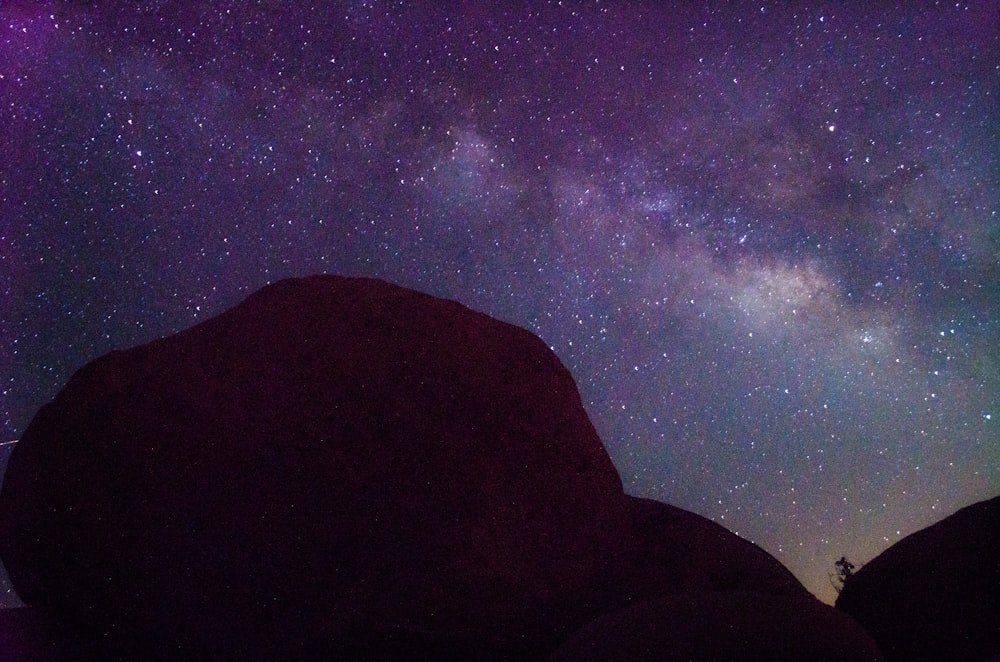 silhouette of mountain during night time