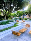 A tranquil outdoor space with seating surrounded by lush greenery.
