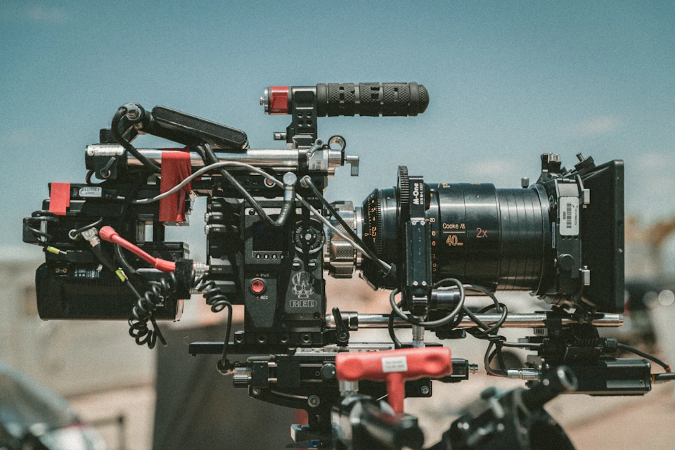 Professional cinema camera rig with a large lens, rails, and a matte box.
