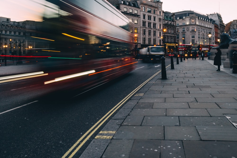 time-lapse photography of vehicle beside pavements