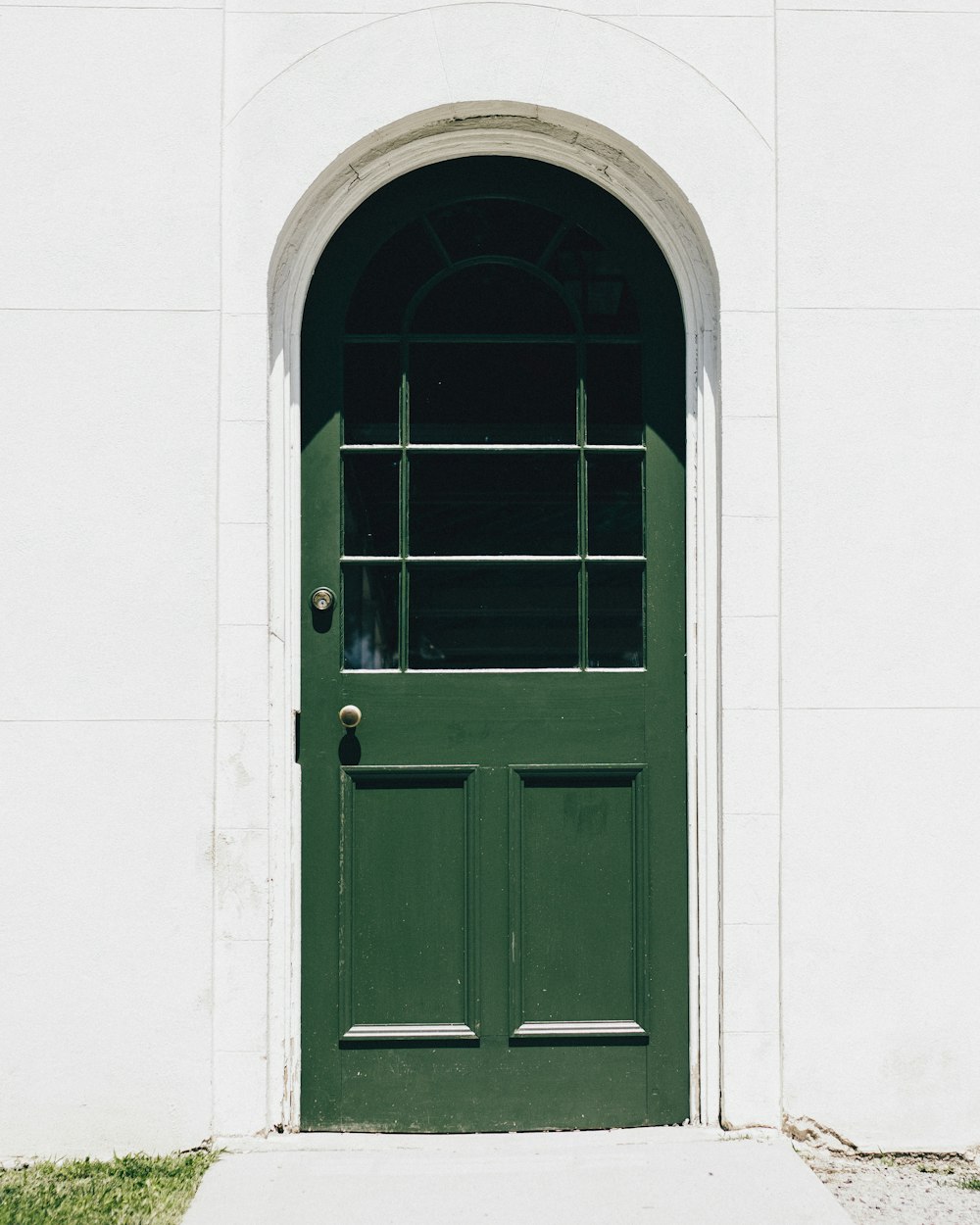 green wooden storm glass door close