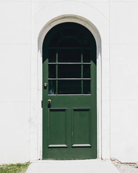 green wooden storm glass door close