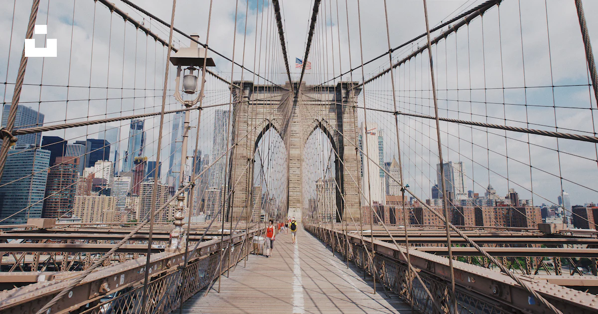 Grey Line Bridge People walking on grey concrete bridge under white clouds during ...