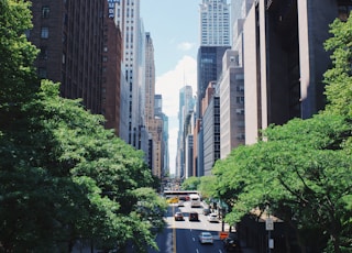 yellow car running on the street between the building during daytime