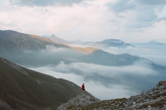 man standing on mountain edge during daytime in Col du Fréjus Italy