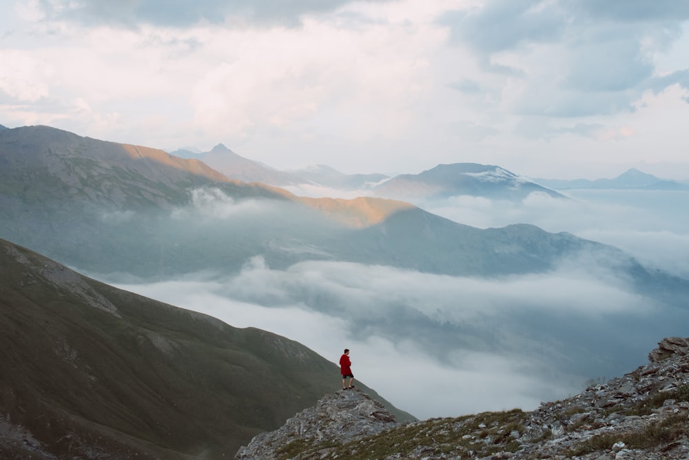 man standing on mountain edge during daytime